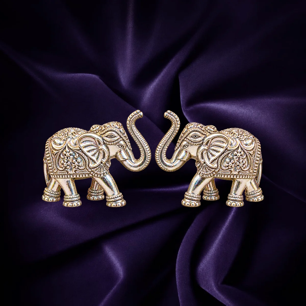 Silver elephant pair idols with raised trunks